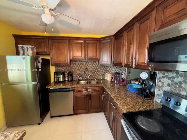 301 Cambridge Rd Unit 302, Hollywood, FL 33024 - kitchen featuring stainless steel appliances, backsplash, light tile patterned floors, and dark stone countertops