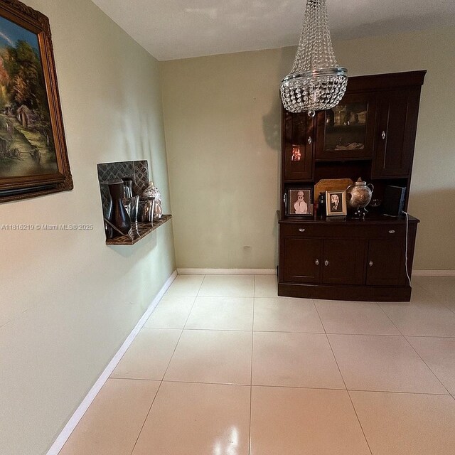 301 Cambridge Rd Unit 302, Hollywood, FL 33024 - dining area with a chandelier and light tile patterned floors