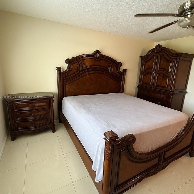 301 Cambridge Rd Unit 302, Hollywood, FL 33024 - bedroom with light tile patterned flooring, ceiling fan, and a textured ceiling