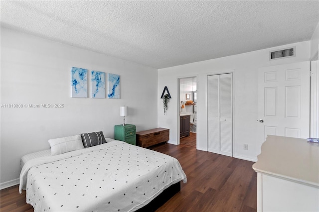 1333 E Hallandale Beach Blvd Unit 421, Hallandale Beach, FL 33009 - bedroom with dark wood finished floors, baseboards, a textured ceiling, a closet, and ensuite bath