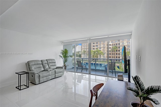 2950 NE 188th St Unit 225, Aventura, FL 33180 - tiled living room featuring expansive windows and baseboards