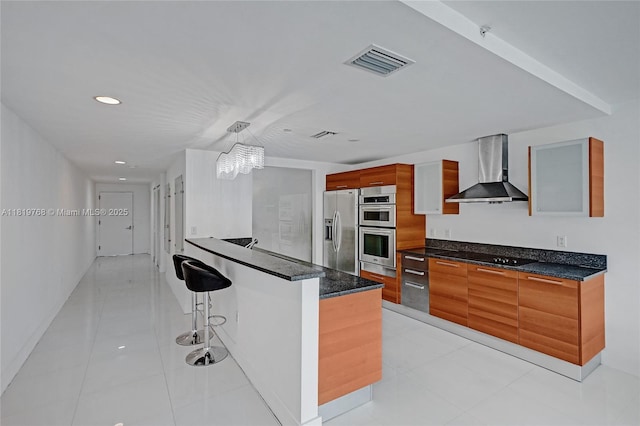2950 NE 188th St Unit 225, Aventura, FL 33180 - kitchen with wall chimney exhaust hood, stainless steel appliances, modern cabinets, a kitchen breakfast bar, and recessed lighting