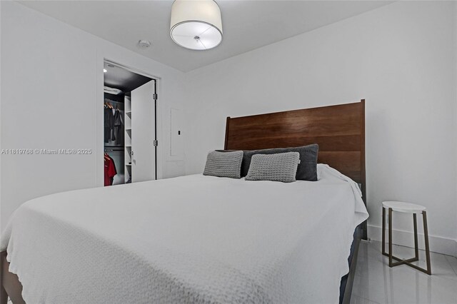 2950 NE 188th St Unit 225, Aventura, FL 33180 - bedroom with baseboards, tile patterned floors, and a walk in closet