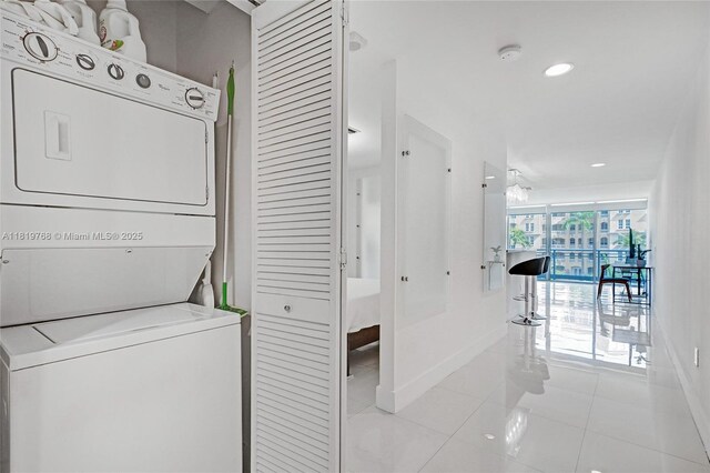 2950 NE 188th St Unit 225, Aventura, FL 33180 - laundry room with stacked washing machine and dryer, tile patterned flooring, baseboards, and recessed lighting
