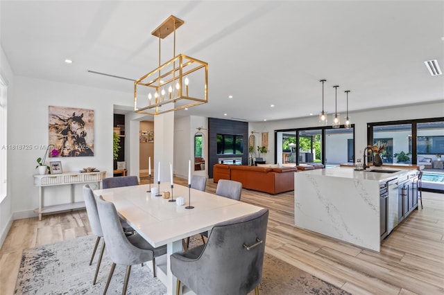 7570 SW 60th St, Miami, FL 33143 - dining area featuring recessed lighting, light wood-style floors, baseboards, and a chandelier