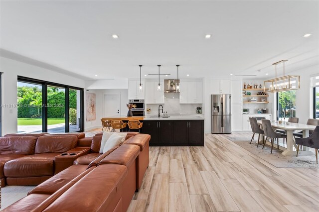 7570 SW 60th St, Miami, FL 33143 - living room with recessed lighting and a chandelier