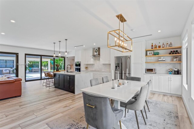 7570 SW 60th St, Miami, FL 33143 - dining room featuring light wood finished floors, a chandelier, and recessed lighting