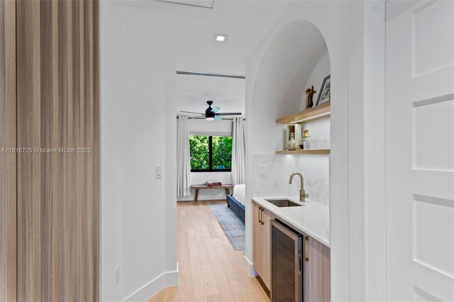 7570 SW 60th St, Miami, FL 33143 - indoor wet bar with wine cooler, light wood-type flooring, a ceiling fan, and baseboards