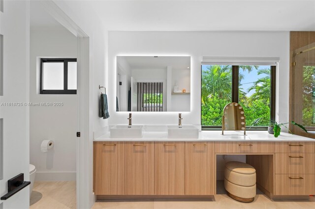 7570 SW 60th St, Miami, FL 33143 - full bathroom with double vanity, toilet, and an enclosed shower