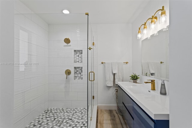 7570 SW 60th St, Miami, FL 33143 - full bath with vanity, a stall shower, wood finished floors, and baseboards