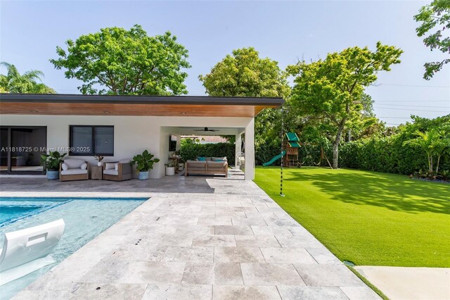 7570 SW 60th St, Miami, FL 33143 - swimming pool featuring an outdoor living space, a patio, ceiling fan, a yard, and a playground