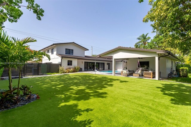 7570 SW 60th St, Miami, FL 33143 - back of house featuring ceiling fan, stucco siding, a patio, and an outdoor hangout area