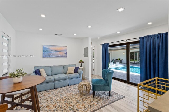 7570 SW 60th St, Miami, FL 33143 - living room featuring light wood finished floors, electric panel, recessed lighting, and baseboards