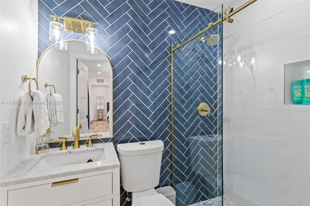 7570 SW 60th St, Miami, FL 33143 - bathroom featuring vanity, toilet, a tile shower, and tile walls