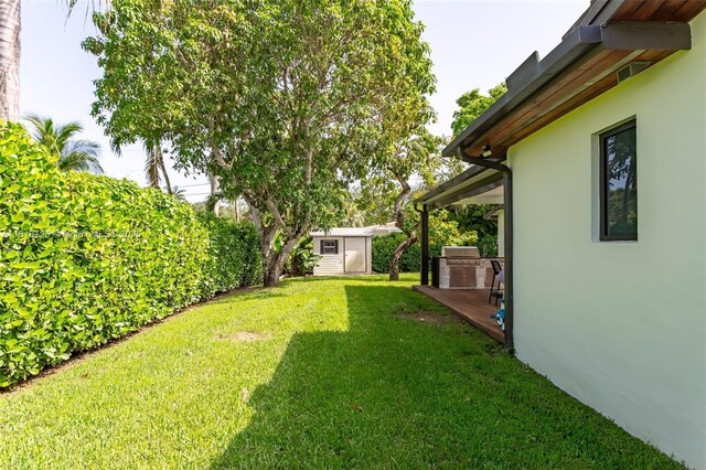 7570 SW 60th St, Miami, FL 33143 - view of grassy yard with a wooden deck