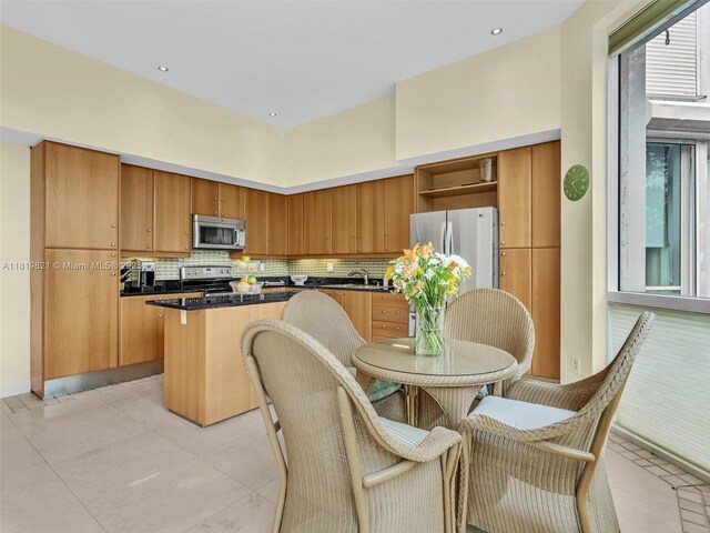 16500 Collins Ave Unit Th-10, Sunny Isles Beach, FL 33160 - kitchen with stainless steel appliances, a center island, open shelves, backsplash, and dark countertops