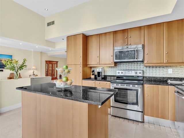 16500 Collins Ave Unit Th-10, Sunny Isles Beach, FL 33160 - kitchen featuring appliances with stainless steel finishes, light tile patterned floors, dark stone countertops, backsplash, and recessed lighting