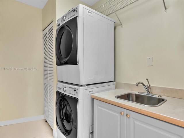 16500 Collins Ave Unit Th-10, Sunny Isles Beach, FL 33160 - laundry room featuring stacked washer / drying machine, cabinet space, and baseboards