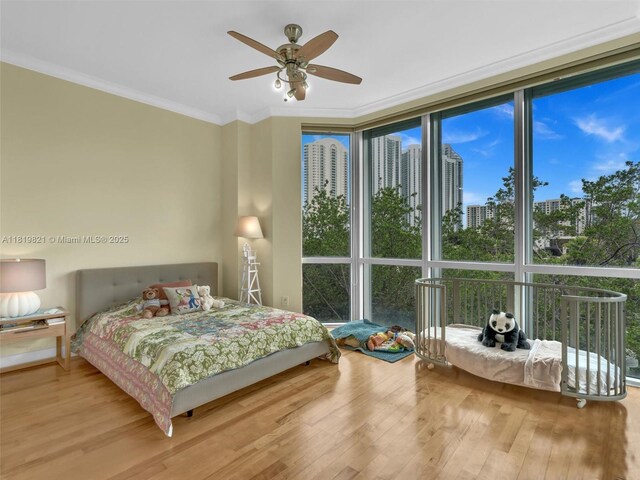 16500 Collins Ave Unit Th-10, Sunny Isles Beach, FL 33160 - bedroom with wood finished floors, a wall of windows, crown molding, and ceiling fan