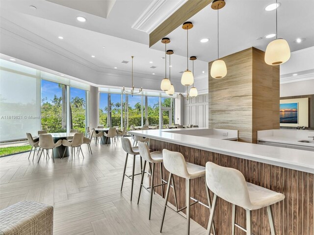 16500 Collins Ave Unit Th-10, Sunny Isles Beach, FL 33160 - kitchen featuring light countertops, crown molding, recessed lighting, a kitchen bar, and decorative light fixtures