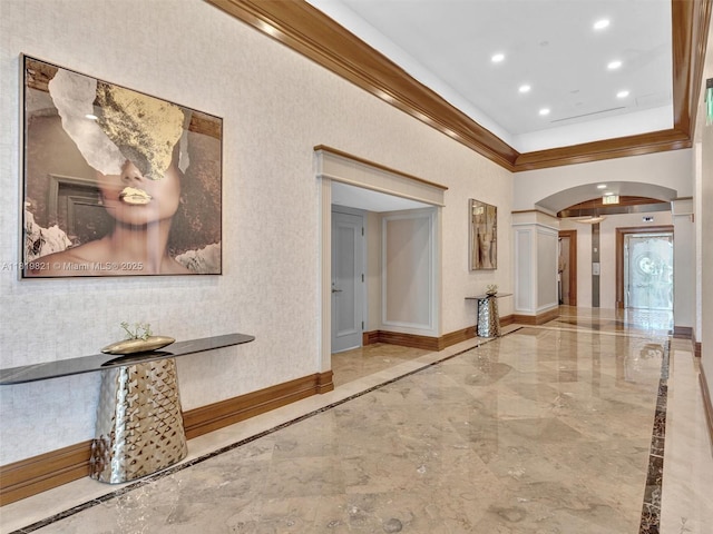 16500 Collins Ave Unit Th-10, Sunny Isles Beach, FL 33160 - hallway featuring inlaid floor details, marble tiled flooring, arched walkways, ornamental molding, and baseboards