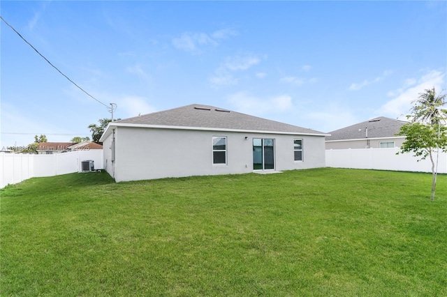 2635 SW Acco Rd, Port St Lucie, FL 34953 - rear view of property with central AC, stucco siding, and a shingled roof