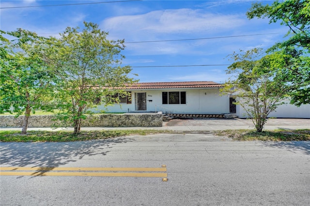 100 NW 23rd Ave, Miami, FL 33125 - ranch-style home with a tile roof and stucco siding