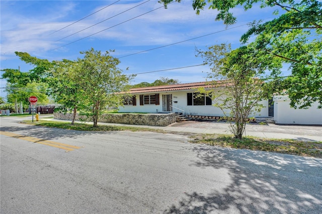 100 NW 23rd Ave, Miami, FL 33125 - single story home with stucco siding and a tiled roof
