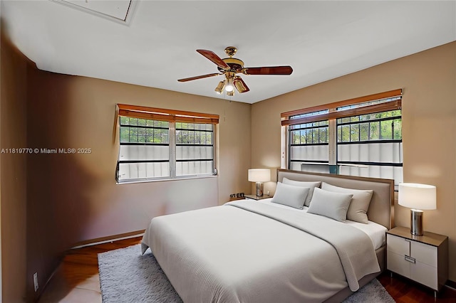 100 NW 23rd Ave, Miami, FL 33125 - bedroom with multiple windows, wood finished floors, and a ceiling fan