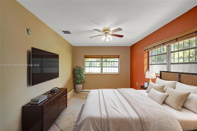 100 NW 23rd Ave, Miami, FL 33125 - bedroom featuring multiple windows, a ceiling fan, and light tile patterned flooring