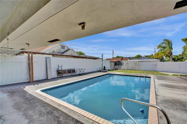 100 NW 23rd Ave, Miami, FL 33125 - view of swimming pool featuring a fenced backyard and a patio