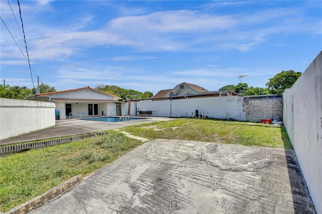 100 NW 23rd Ave, Miami, FL 33125 - fenced backyard featuring a patio