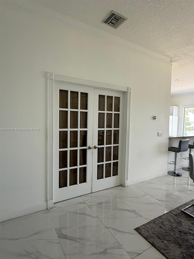 17018 SW 52nd Ct, Miramar, FL 33027 - spare room featuring marble tiled flooring, french doors, crown molding, baseboards, and a textured ceiling