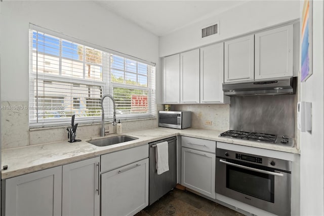 760 Meridian Ave Unit 3, Miami Beach, FL 33139 - kitchen with stainless steel appliances, a sink, under cabinet range hood, tasteful backsplash, and healthy amount of natural light