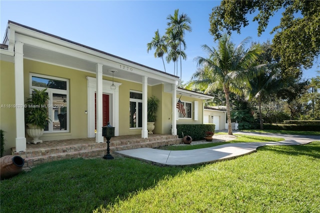 1270 Mariola Ct, Coral Gables, FL 33134 - view of front of home featuring covered porch, a front yard, stucco siding, and an attached garage