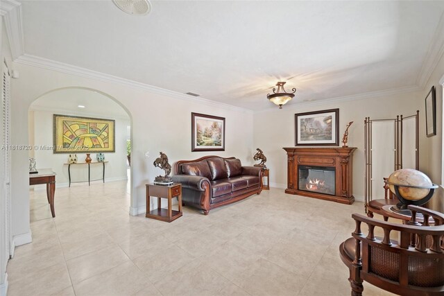 6231 SW 27th St, Miami, FL 33155 - living room featuring arched walkways, crown molding, a glass covered fireplace, and light tile patterned floors