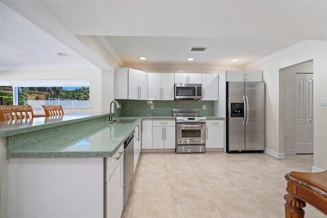 6231 SW 27th St, Miami, FL 33155 - kitchen featuring appliances with stainless steel finishes, tasteful backsplash, crown molding, white cabinets, and light tile patterned floors