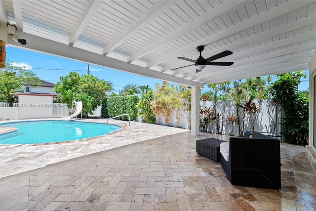 6231 SW 27th St, Miami, FL 33155 - view of swimming pool with a water slide, a patio, a fenced backyard, and ceiling fan