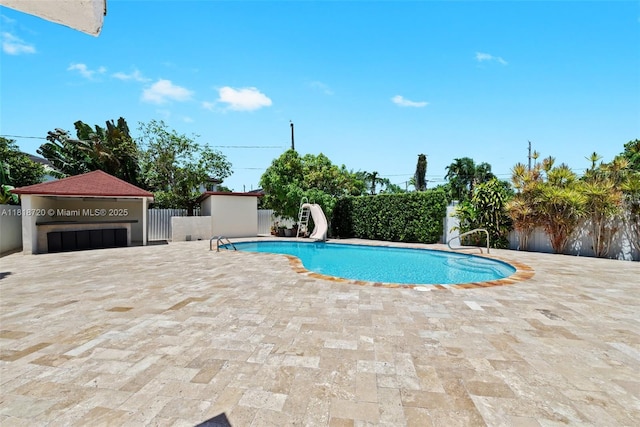 6231 SW 27th St, Miami, FL 33155 - view of swimming pool featuring a water slide and a patio area