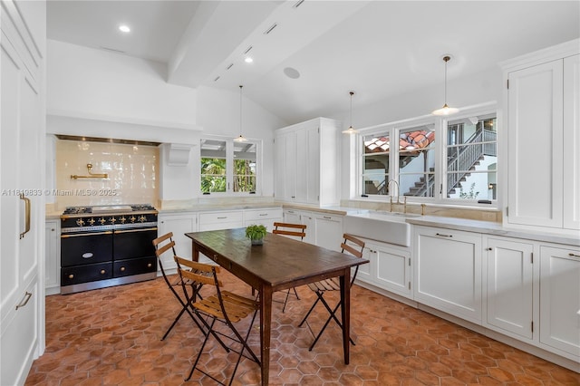 dining space with vaulted ceiling and recessed lighting