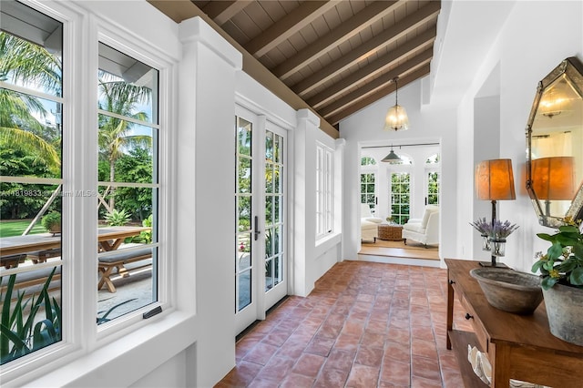 doorway featuring healthy amount of natural light and wood ceiling