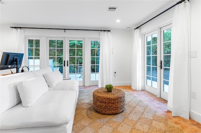 living area with french doors, baseboards, and recessed lighting
