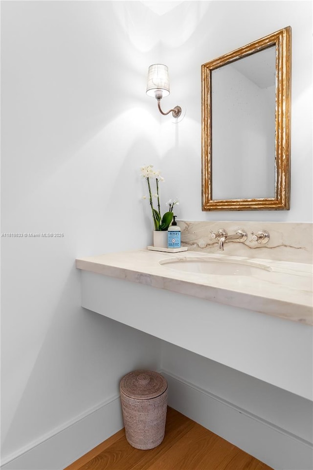 bathroom with vanity and wood finished floors