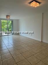 8888 Collins Ave Unit 318, Surfside, FL 33154 - empty room with tile patterned flooring and baseboards