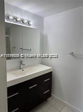 8888 Collins Ave Unit 318, Surfside, FL 33154 - bathroom with vanity, tile patterned floors, and baseboards