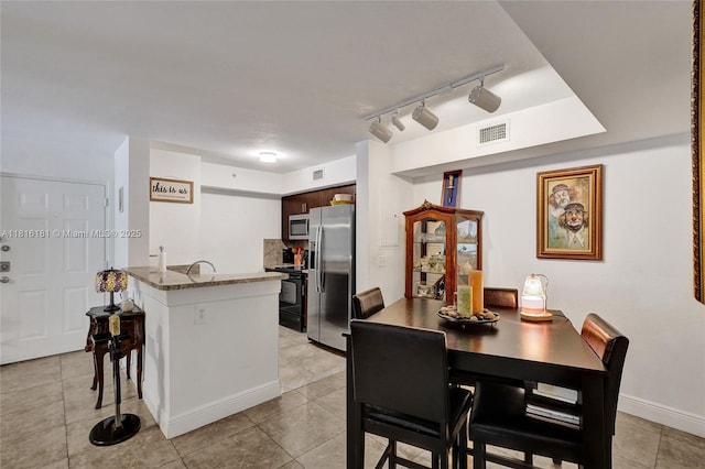 15400 SW 284th St Unit 1204, Homestead, FL 33033 - dining space featuring track lighting and light tile patterned floors