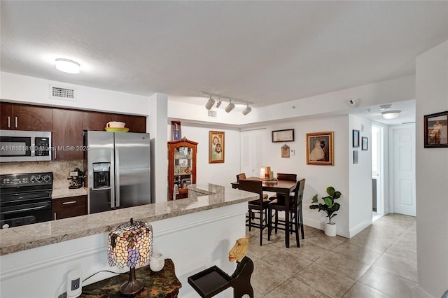 15400 SW 284th St Unit 1204, Homestead, FL 33033 - kitchen with stainless steel appliances, light countertops, and dark brown cabinets