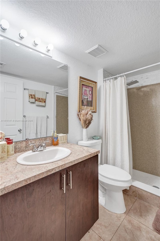 15400 SW 284th St Unit 1204, Homestead, FL 33033 - full bathroom featuring vanity, tile patterned flooring, a stall shower, and a textured ceiling
