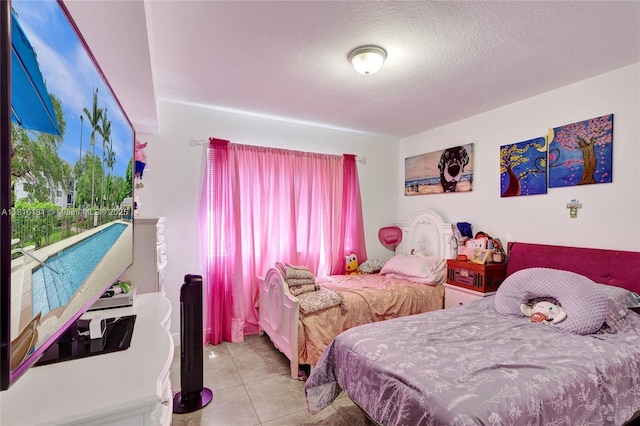 15400 SW 284th St Unit 1204, Homestead, FL 33033 - bedroom featuring multiple windows, a textured ceiling, and light tile patterned floors