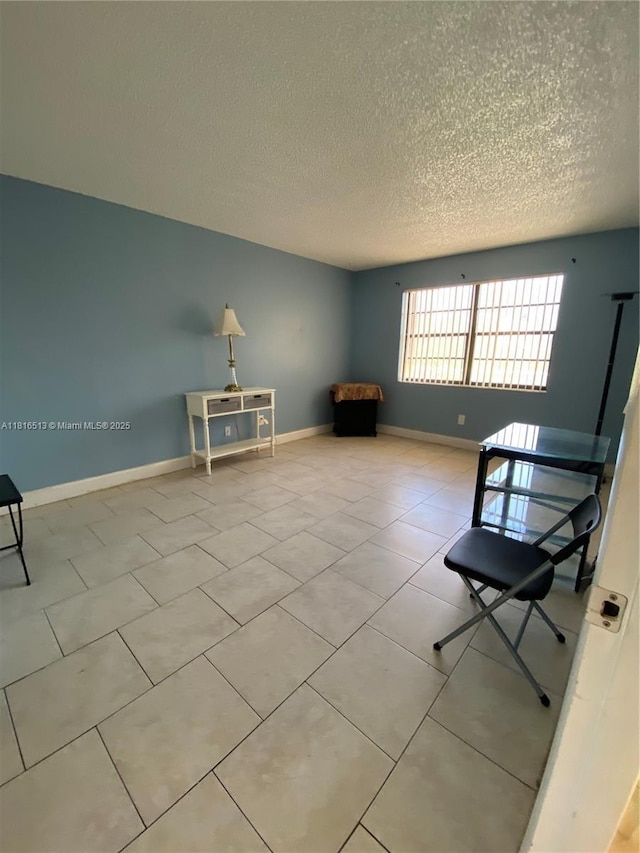9301 SW 92nd Ave Unit A320, Miami, FL 33176 - living area with a textured ceiling, baseboards, and tile patterned floors